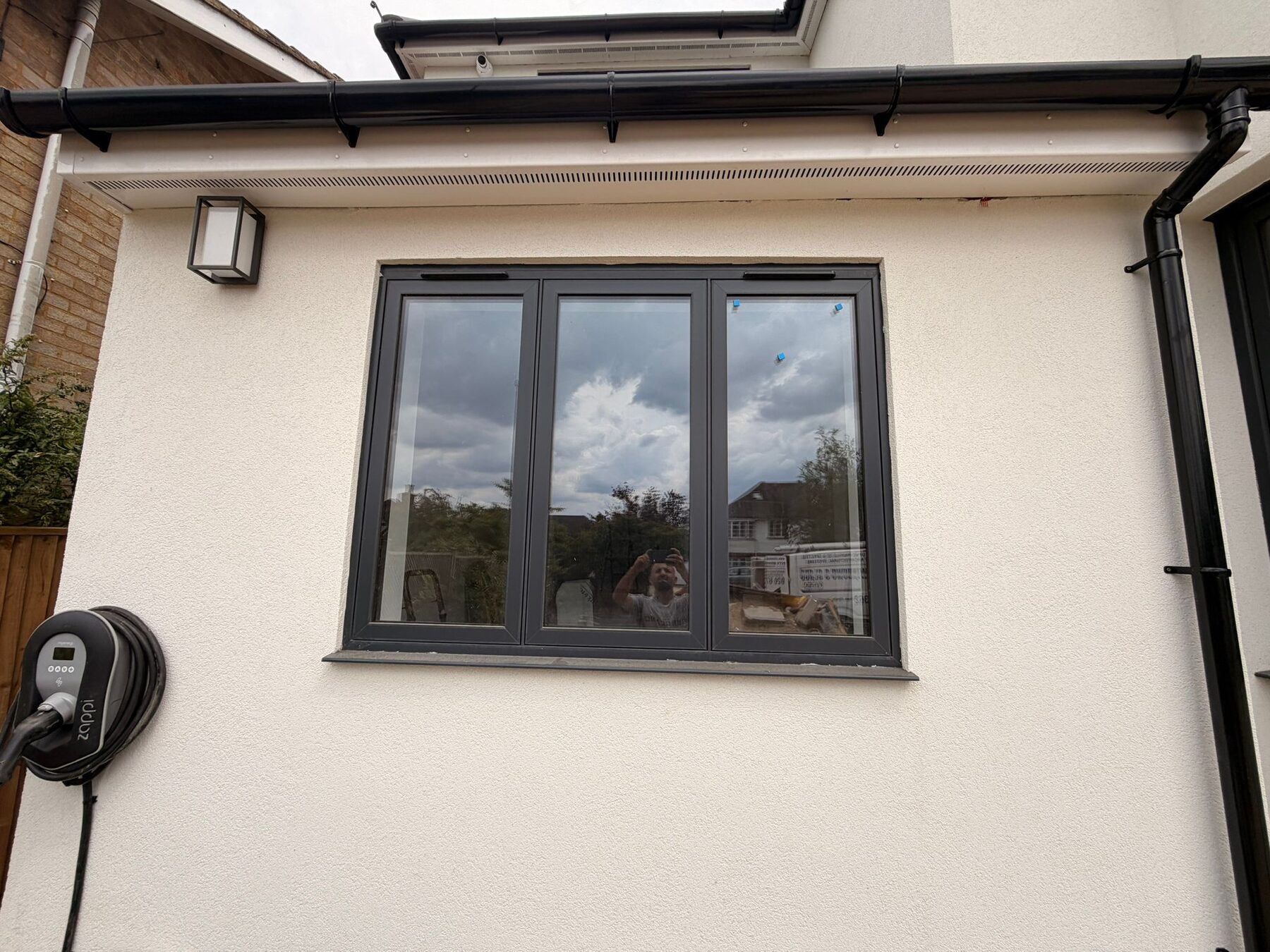 Slim-framed black picture window in white render