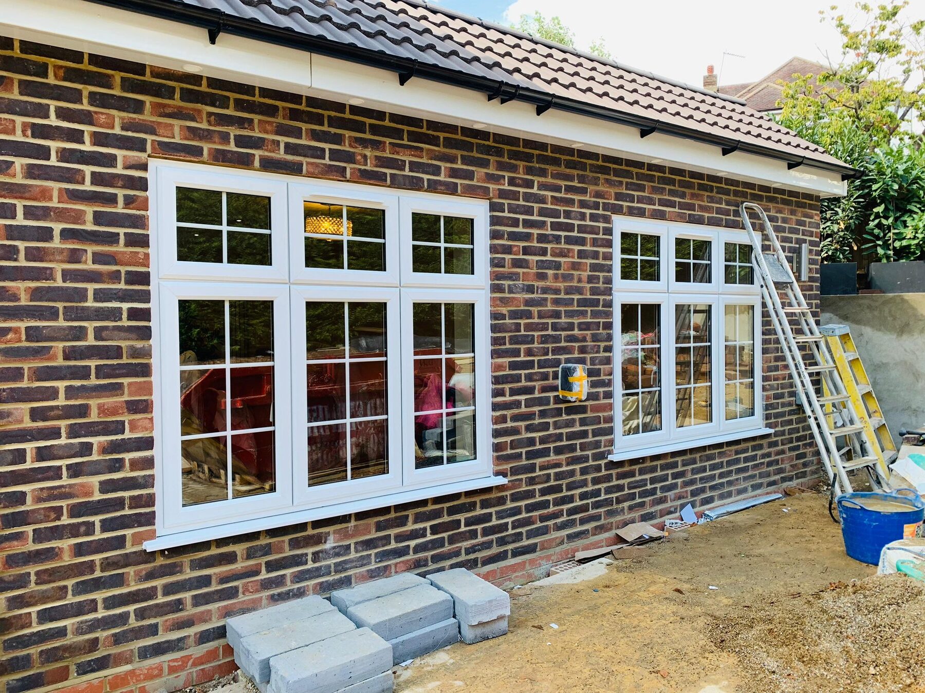 White uPVC windows with Georgian bars on a brick bungalow